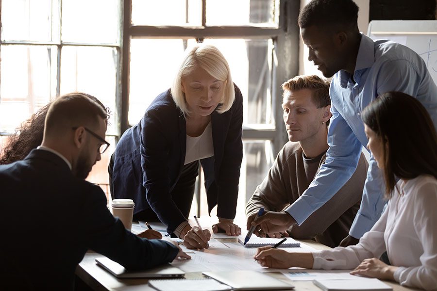 Business Insurance - Group Of Employees Working Together In Office